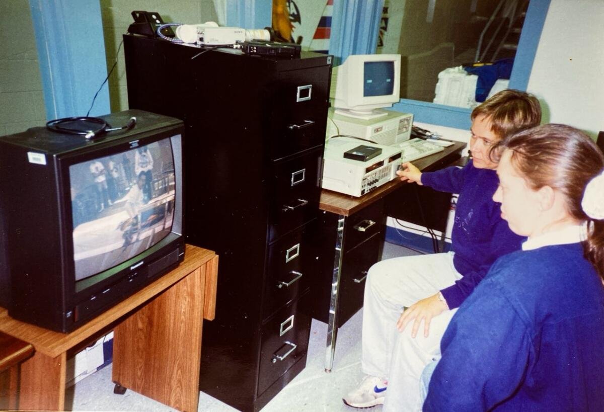 Two women looking at a computer.