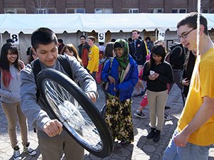 Student with bicycle wheel